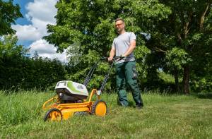AS-Motor AS 510 E-ProClip A AP in action mowing grass, young man walking behind the mower