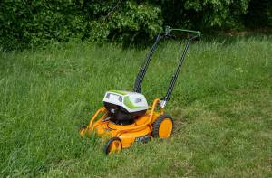 AS-Motor AS 510 E-ProClip A AP in action mowing grass, young man walking behind the mower